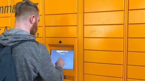 Man using Amazon Locker in shopping mall Stock Footage 125533261