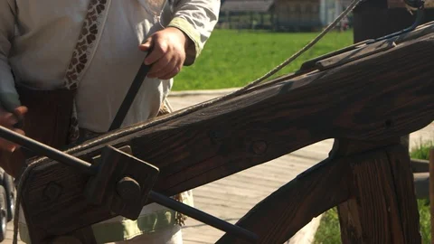 Man using ancient wooden catapult outdoor. Stock Footage 113915667