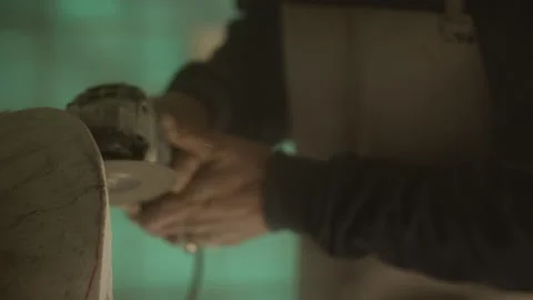 Man using an angle grinder to make a sculpture Stock Footage 275000407