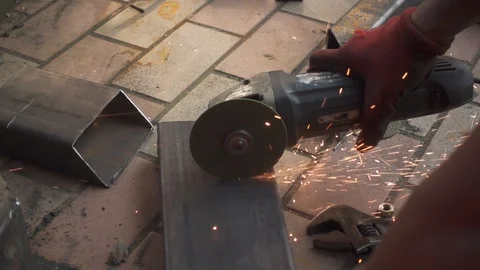 Man using angle grinders in workshop Stock Footage 99982685