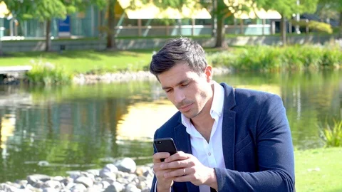 Man using app on phone outside in modern business park 4K Stock Footage 96062784