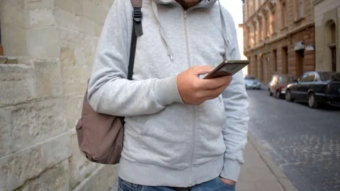 Man using app on smart phone in old city. Stock Footage 79392461