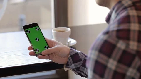 Man using app on smartphone in cafe Stock Footage 73020996