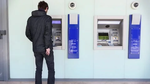 Man Using ATM Bank Machine Outdoors Stock-Footage 62678537