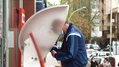Man Using ATM Bank Machine Outdoors. Automated teller machine is an electronic Stock Footage 182812777