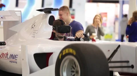 Man using auto simulator with virtual glasses in game center Stock Footage 59621967