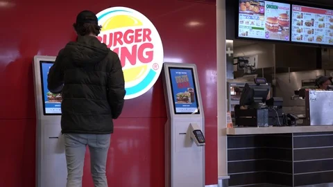 Man using automated ordering kiosk at Burger King Calgary Airport 4k Stock-Footage 119191023