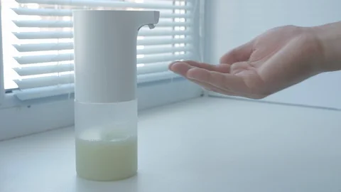 Man using automatic foam soap dispenser, washing hands, close, macro, on the Stock Footage 129333479