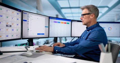 Man Using Automatic Salary Calculation Software For Tax Accounting Charters. Stock Photos
