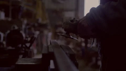 Man using an axle grinder in a workshop Stock Footage 279773924