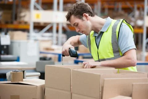 Man using barcode reader in warehouse Stock Photos