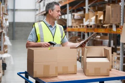 Man using barcode reader in warehouse Stock Photos