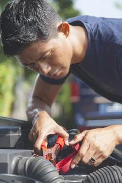 Man using battery jumper cables on a dead battery Stock Photos