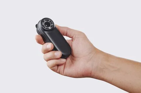 Man using a battery-powered fan to refresh himself Stock Photos