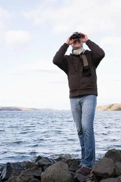 A man using binoculars Stock Photos