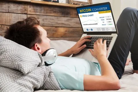 Man using Bitcoin converter website to trade bitcoin price. Stock Photos