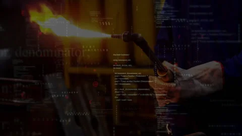 Man using blowtorch in manufacturing technology workshop, showing floating code 库存影片 308100720