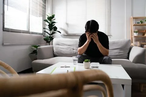 Man using both hands to covering faces with emotional of stressed and depre.. Stock Photos