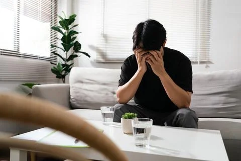 Man using both hands to covering faces with emotional of stressed and depre.. Stock Photos