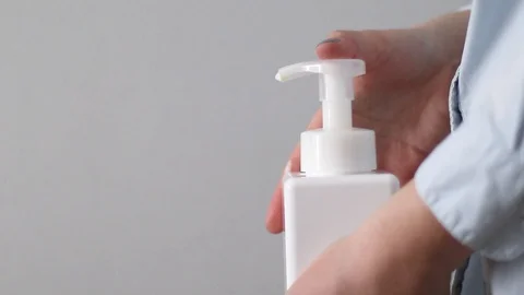 Man using a bottle of antibacterial disinfectant soap, hygiene prevention of an Stock Footage 127637125