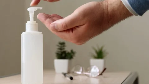 Man using bottle with antibacterial sanitiser soap for hand care Stock Footage 128588027
