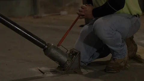 Man Using Bottle Jack Further Back Stock Footage 100827595