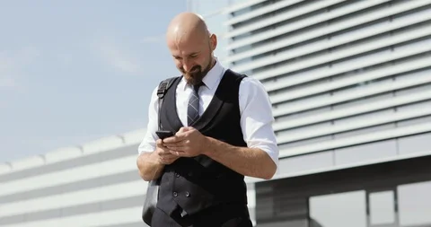 Man using business app on smart phone walking in city. Handsome young Stock Footage 94823550