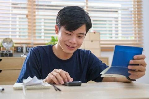 Man using calculator and counting money and making notes at home. Investmen.. Stock Photos