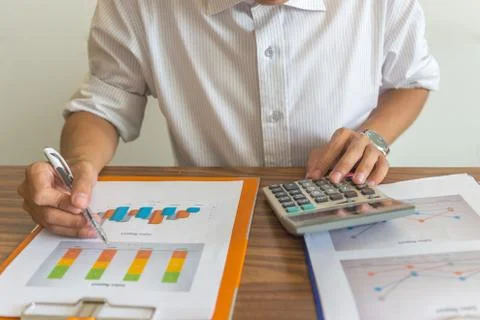 Man using calculator to check financial report Stock Photos