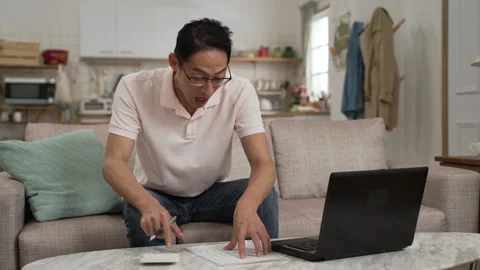 Man using calculator happy about saving increases Stock Footage 251218165