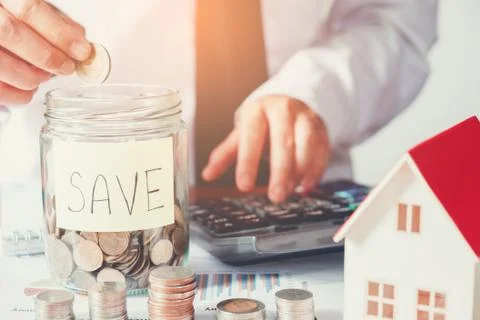Man using calculator Save money for home cost Stock Photos