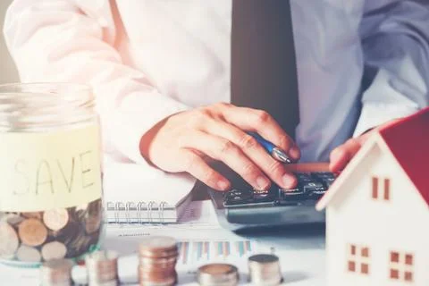 Man using calculator Save money for home cost Stock Photos