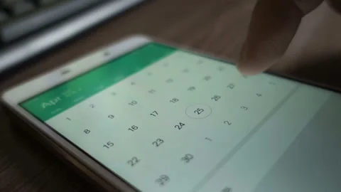 Man using calendar app on the mobile device closeup. Close-up male hands scro Stock Footage 125384061