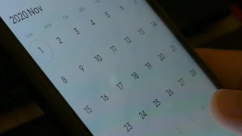 Man using calendar app on the mobile device. Male hands scrolling on smartphone. Stock Footage 126774188