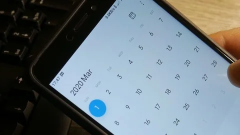 Man using calendar app on the mobile device. Male hands scrolling on smartphone. Stock Footage 126774192