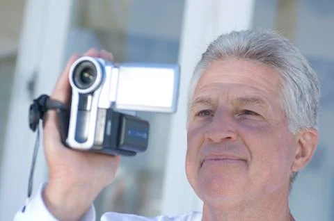 Man using camcorder Stock Photos