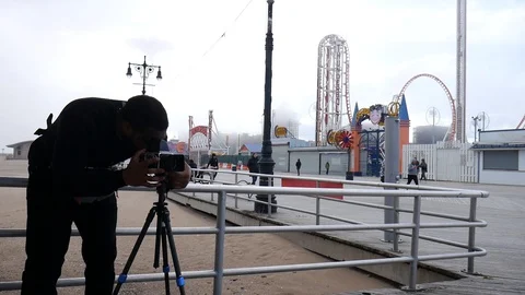 Man Using Camera Boardwalk Coney Island Foggy Day Stock Footage 129581196