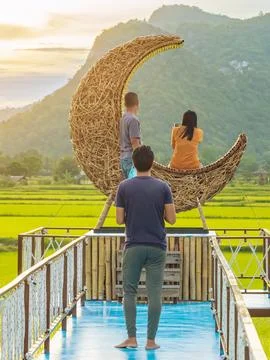 Man using camera to take photo with happiness young couple on crescent moon.. Stock Photos