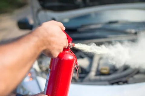 Man using car to extinguish a car fire. Close up shot Stock Photos