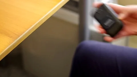 A man using a cell phone at his desk. 스톡 동영상 76784567