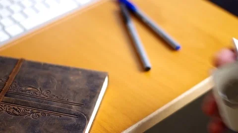 A man using a cell phone at his desk. Stock Footage 76784574