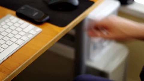 A man using a cell phone at his desk. Stock Footage 76784581