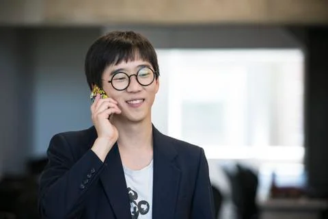 Man using cell phone, smiling cheerfully Stock Photos