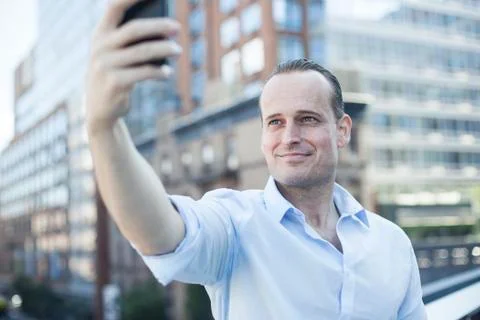 Man using cell phone to take a selfie Stock Photos