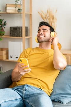 Man using cell phone while relaxing at home. Foto stock
