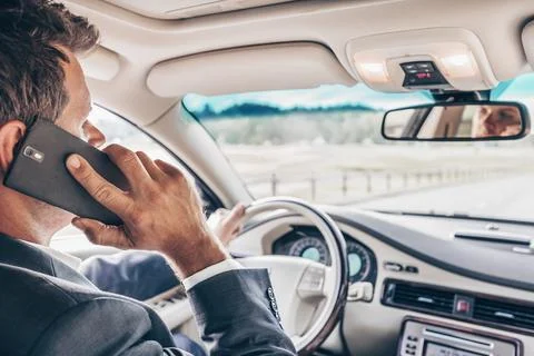 Man using cell phone while driving Stock Photos