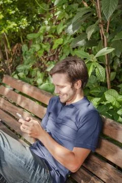Man using a cellphone in the park Foto stock