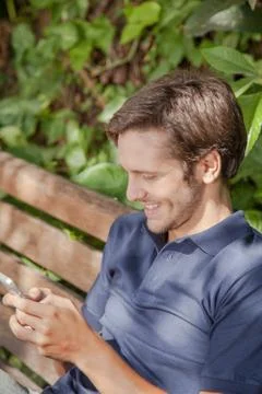 Man using a cellphone in the park Fotos Stock