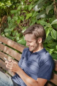 Man using a cellphone in the park Stock-Fotos