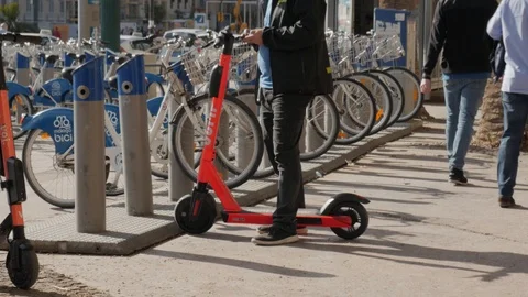 Man using cellphone to unlock an electric shared scooter Stock Footage 120734513